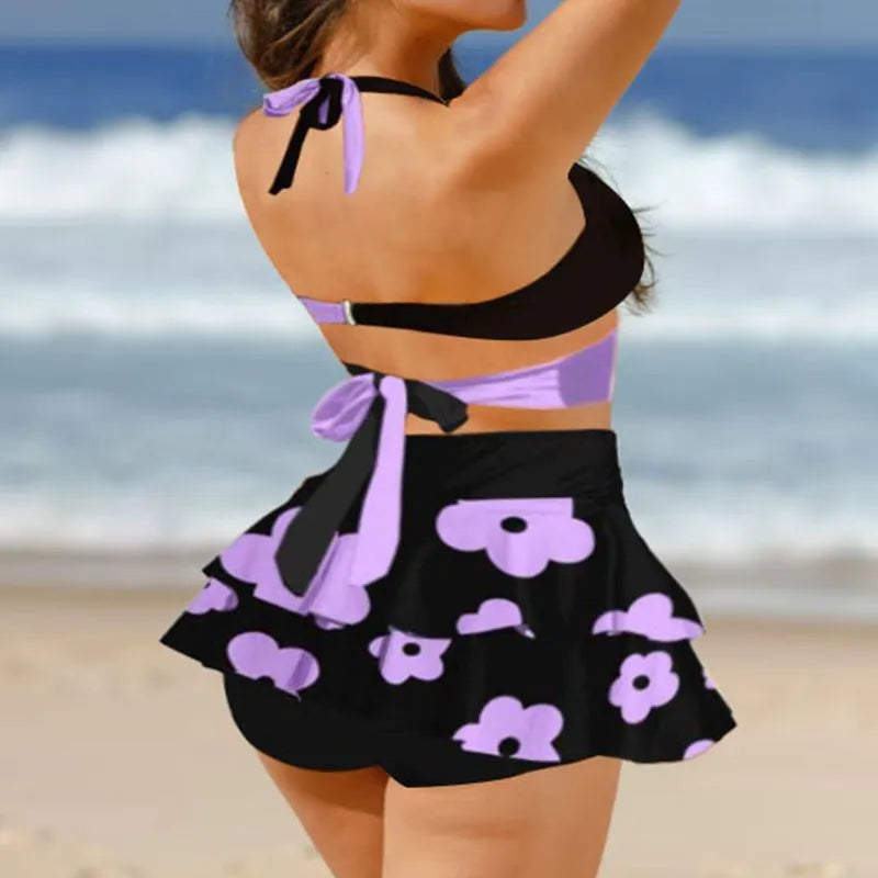 Purple women's high-waisted bikini swimsuit with lace-up detail and matching skirt for swimming