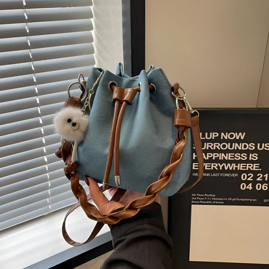 Blue synthetic leather cross body bucket bag with sandwich pocket and one-shoulder strap