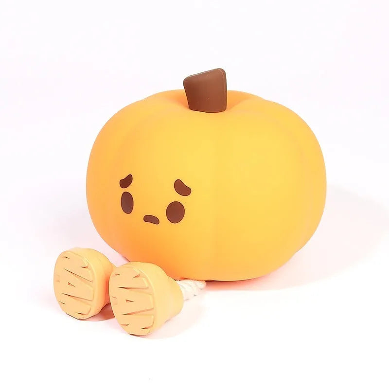 Orange silicone pumpkin night light with USB charging port and cotton accents, displayed as decorative lantern