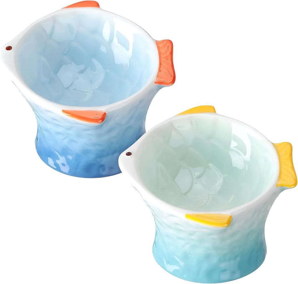 Blue ceramic fish-shaped cat bowl with tilted design and non-slip base on a wooden surface