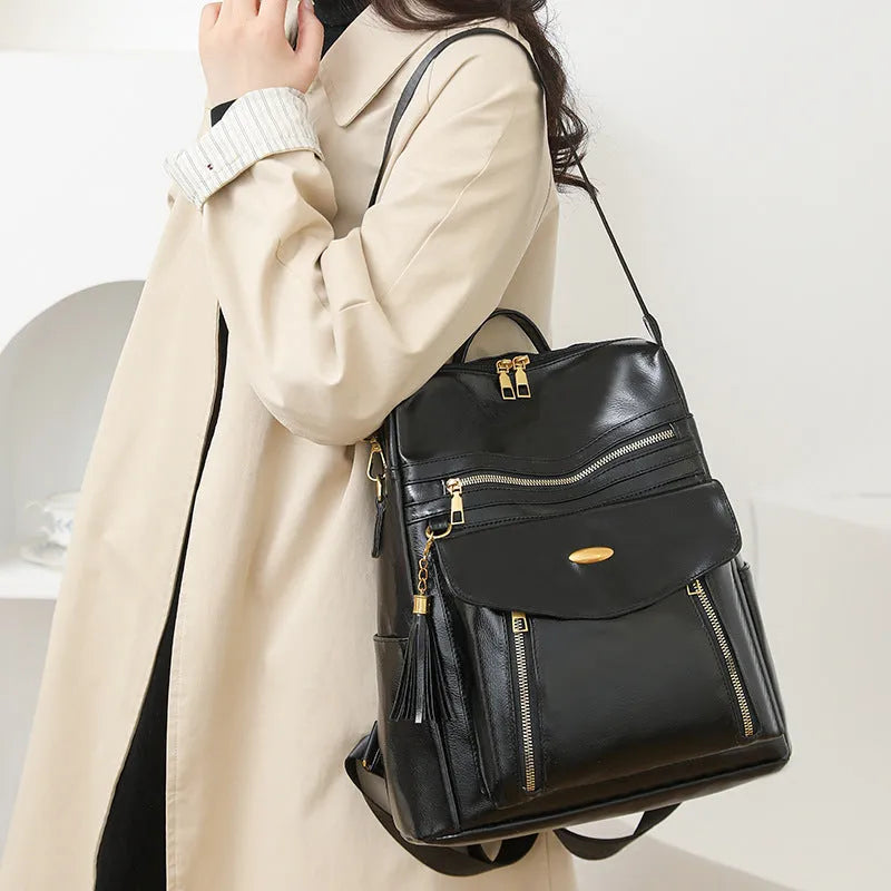 Crossbody casual ladies backpack in PU with soft construction, sewing thread details, black colour, phone pocket