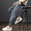 A pair of men's loose-fit cargo jeans in a blue colour, showing the straight leg and casual style.