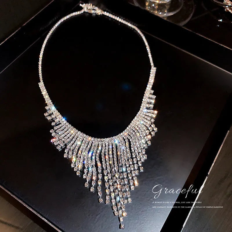Silver alloy diamond tassel necklace with geometric pendant and ball bead chain on a white background