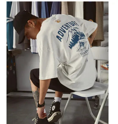 Man wearing a black loose-fit short-sleeved t-shirt, plus size casual summer top.