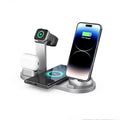 Black three-in-one wireless charger and phone holder on a desk showing iPhone charging.