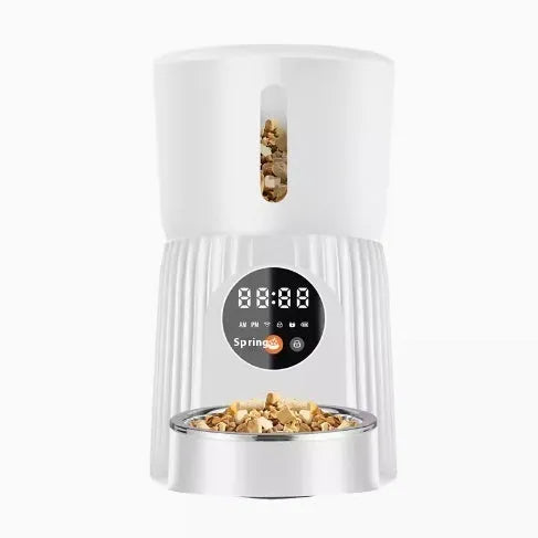 Black and white automatic pet feeder with digital timer and USB cable for remote, portion-controlled feeding.