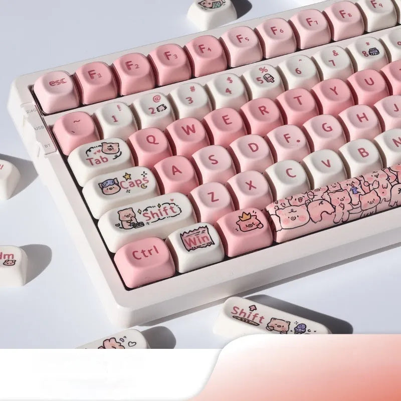 Set of pastel pink PBT key caps with a fragrant pig design, shown with a key puller tool.