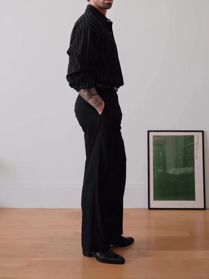 Men's black pinstriped button-down long sleeve shirt made from polyester fabric.