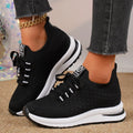 Women's black and white mesh lace-up flat pumps with a round toe and rubber sole.