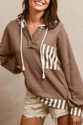 Straw yellow striped hoodie with waffle texture patchwork, button neck, and drawstring hood laid flat.