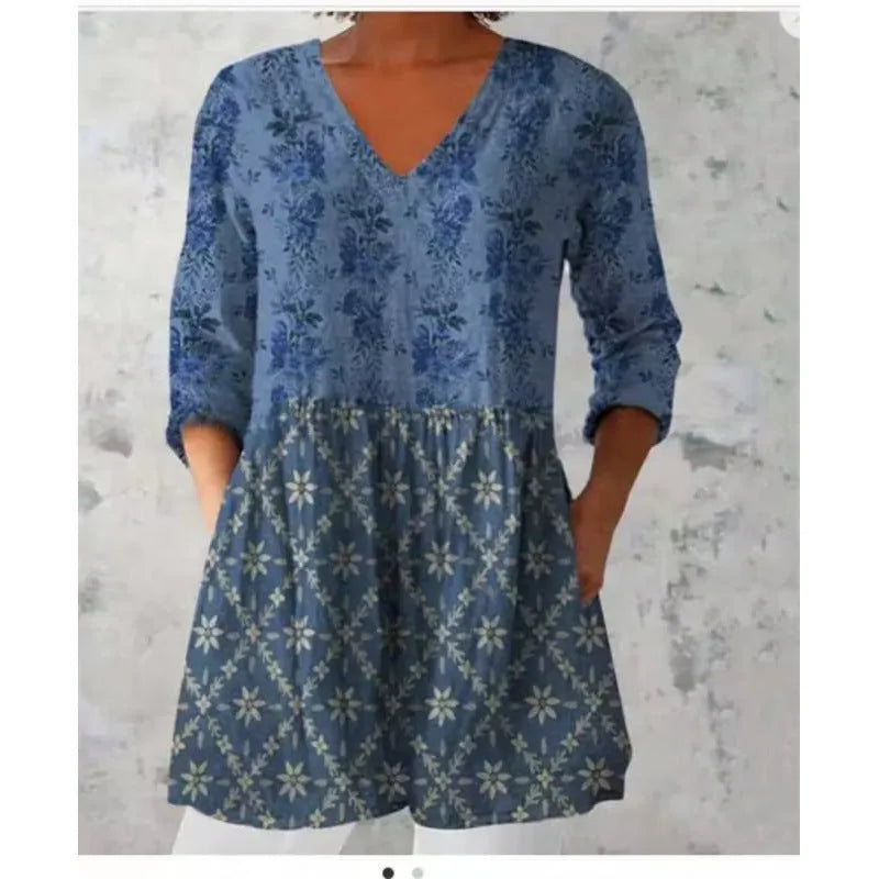 A woman wearing a loose-fitting floral print dress with 3/4 ruffle sleeves and a wide waist.