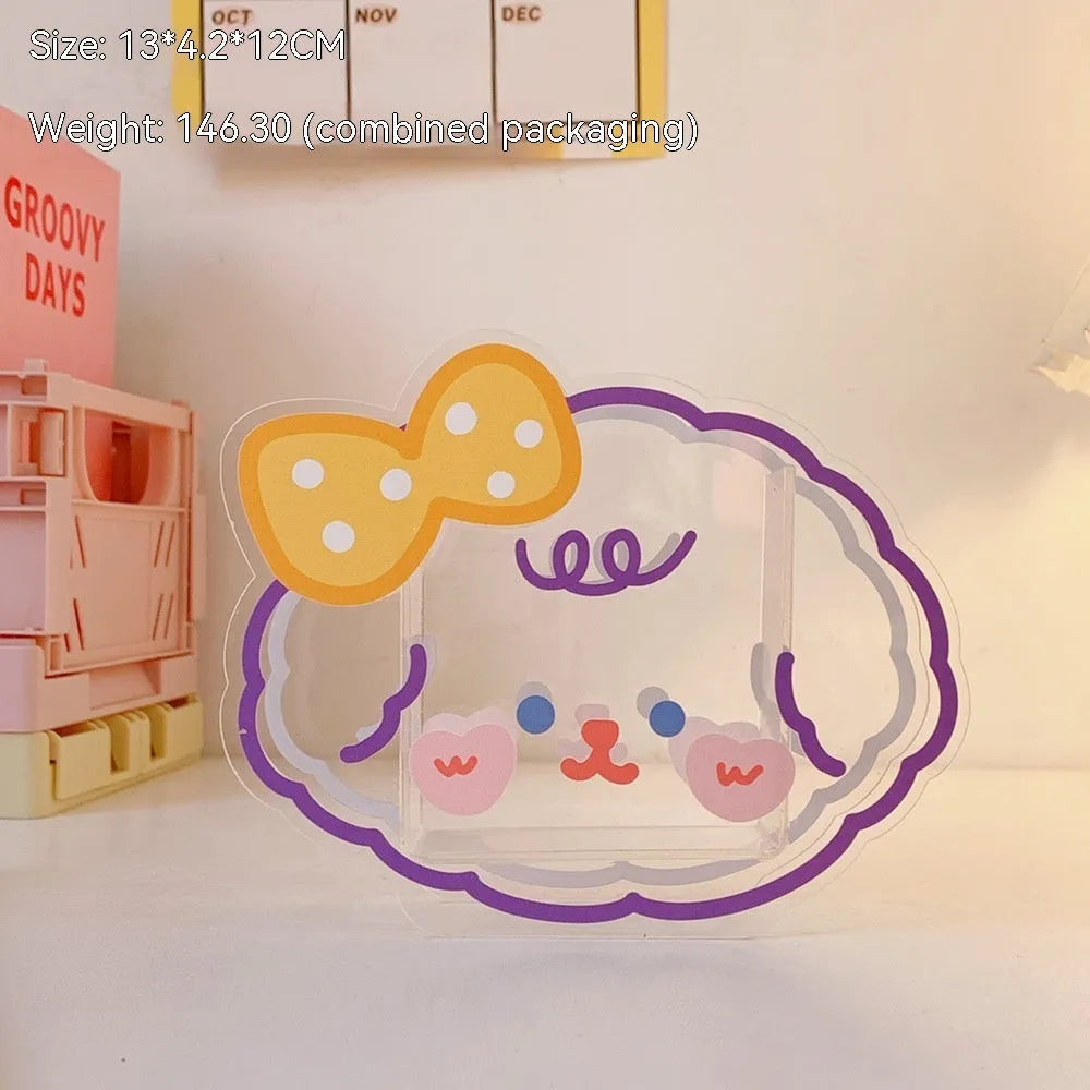 Square transparent acrylic storage box with a cute decorative design, shown on a desk.
