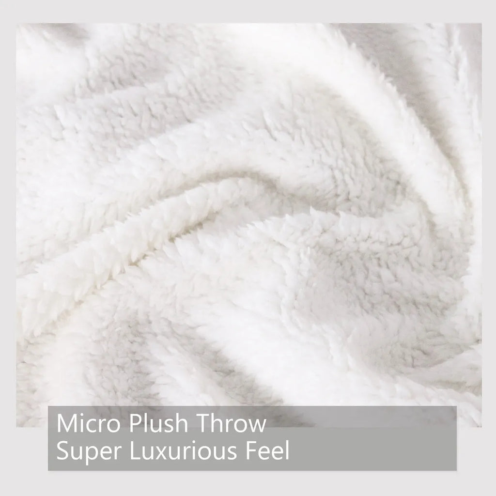 Black turtle pattern Sherpa fleece blanket on sofa, soft warm throw for home or camping