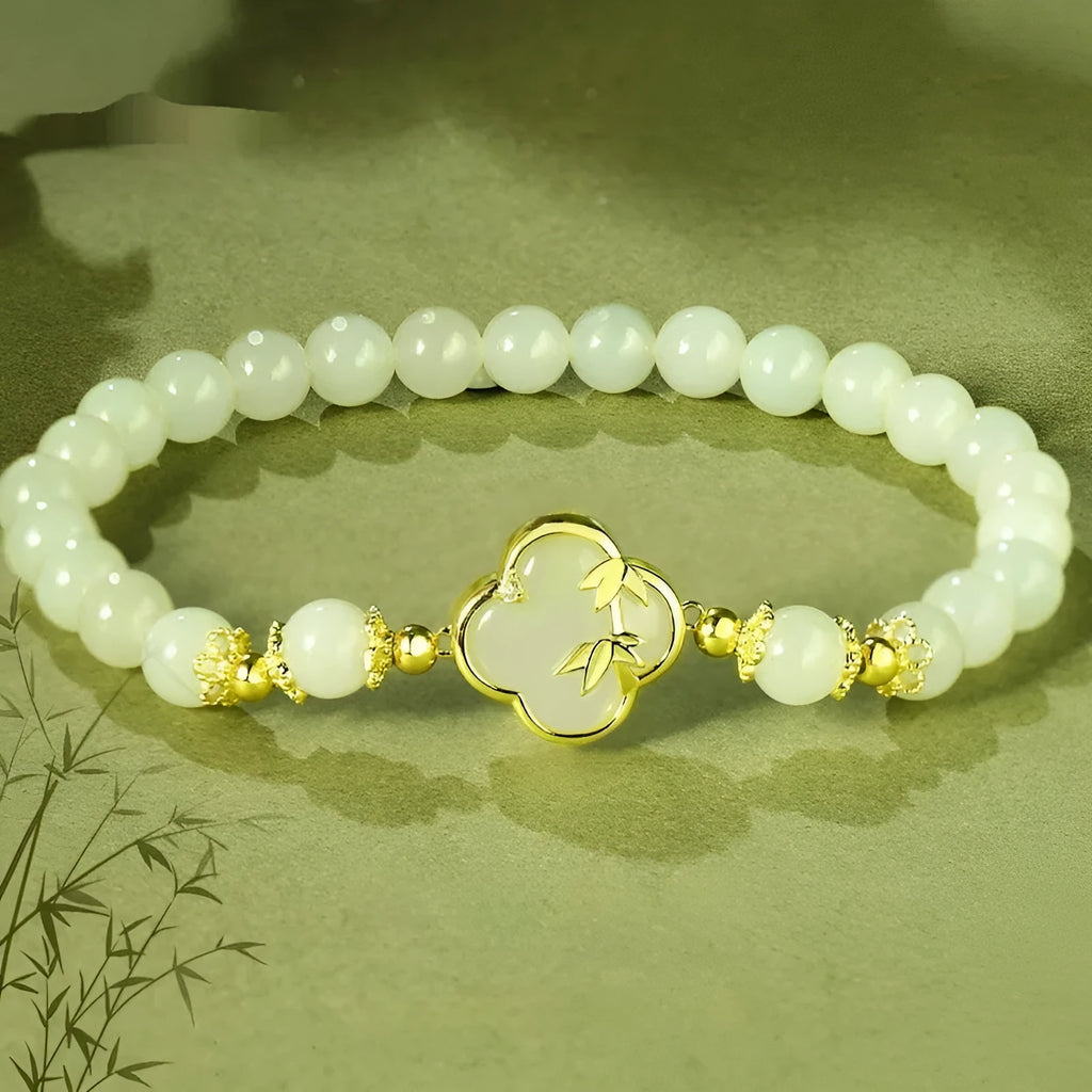 Hetian Jade festival bracelet and necklace set with inlaid jade leaf designs on bamboo newspaper tone background