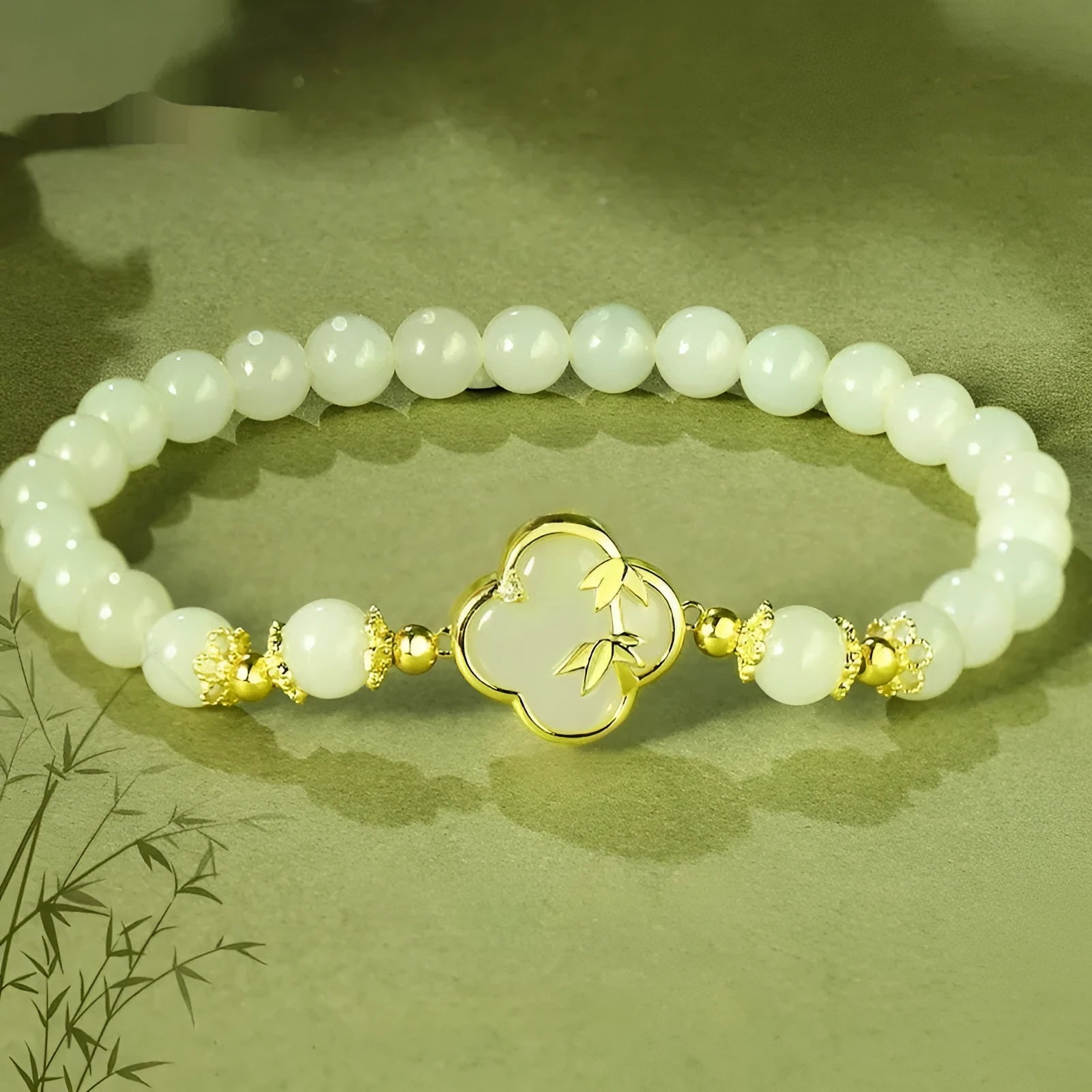 Hetian Jade festival bracelet and necklace set with inlaid jade leaf designs on bamboo newspaper tone background