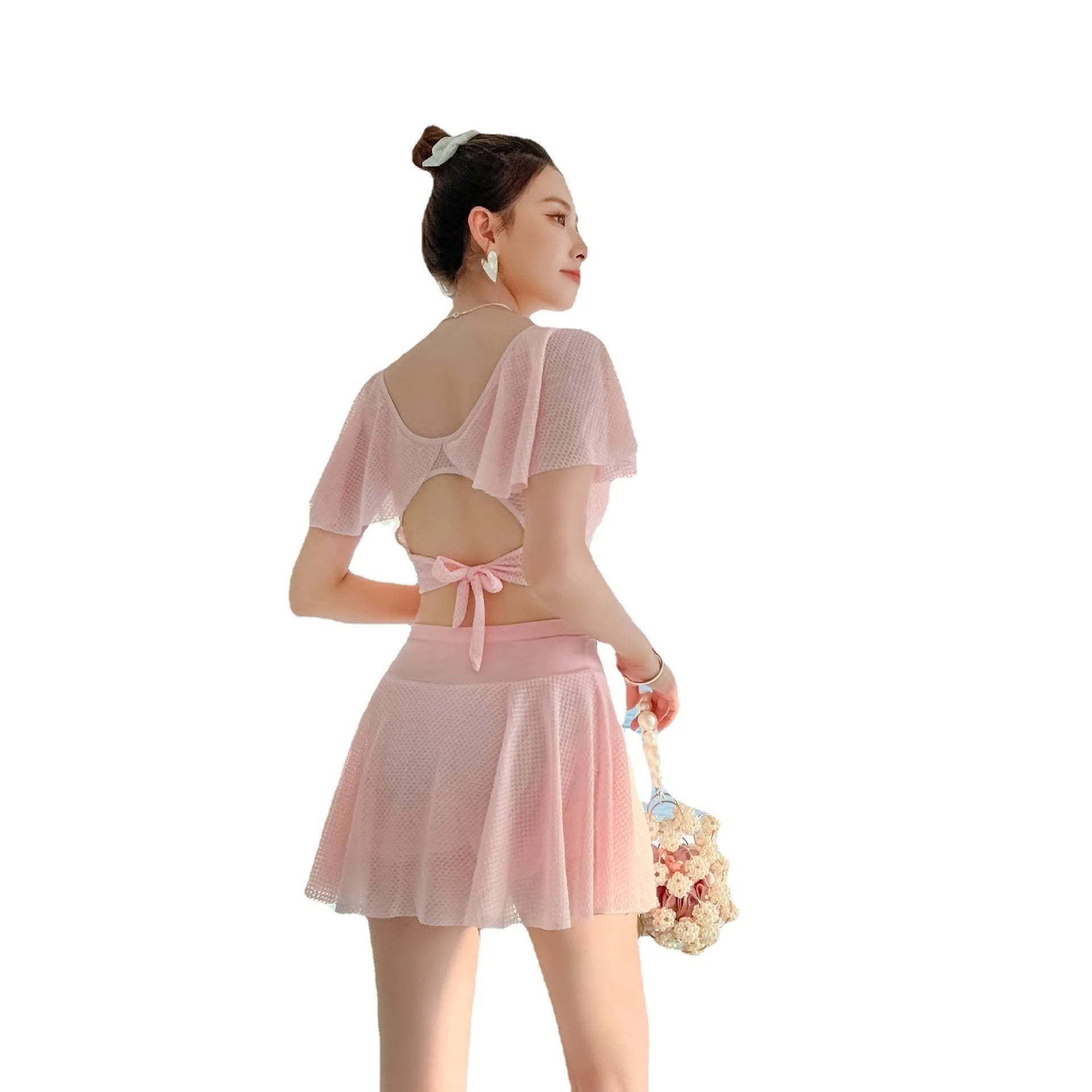 Women's solid colour two-piece swimsuit with a separate top and skirt.