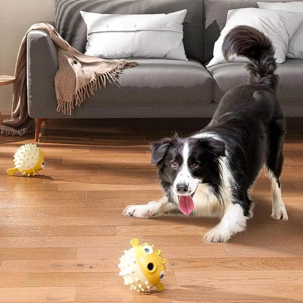 A yellow, fish-shaped durable dog chew toy with a textured surface and built-in squeaker.