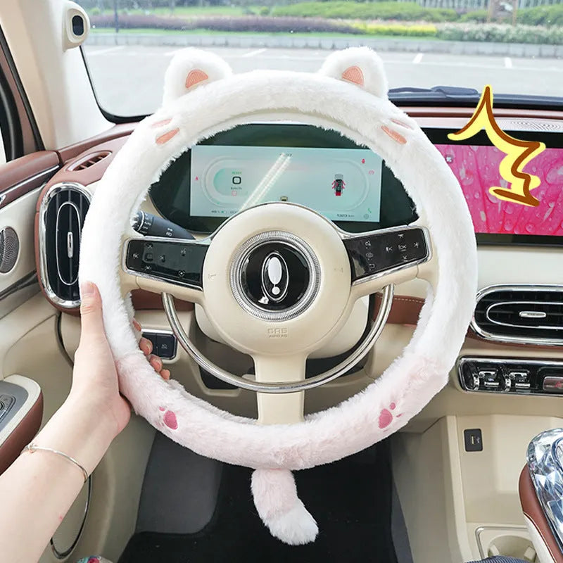 Plush winter steering wheel cover with embroidered bear design, shown on a car steering wheel.