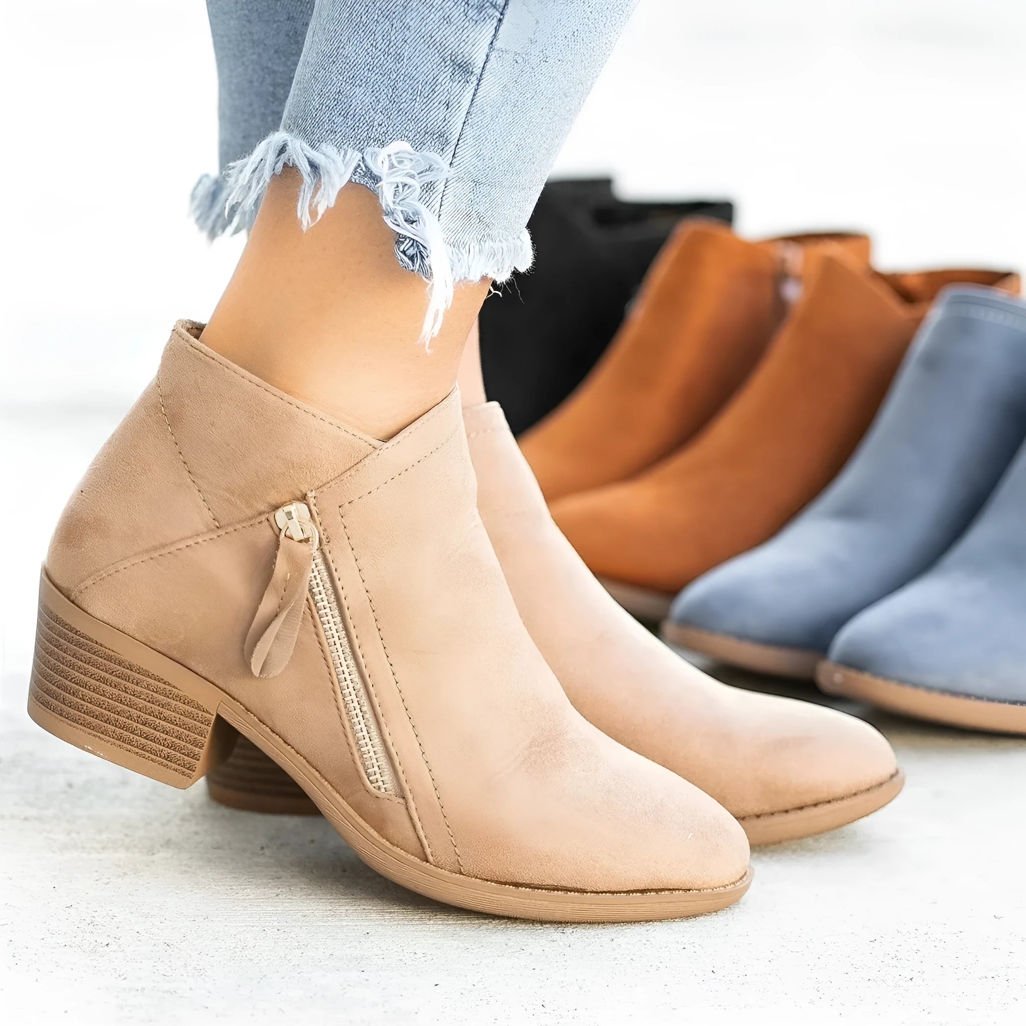 Women's suede ankle boot with side zipper and chunky heel in beige, black, blue, or orange.