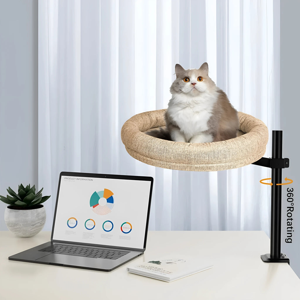 Round grey cloth cat nest with rotating base and adjustable height on a floor