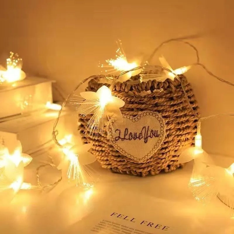 LED optical fibre flower light string with 20 warm white beads and battery box on a table decoration