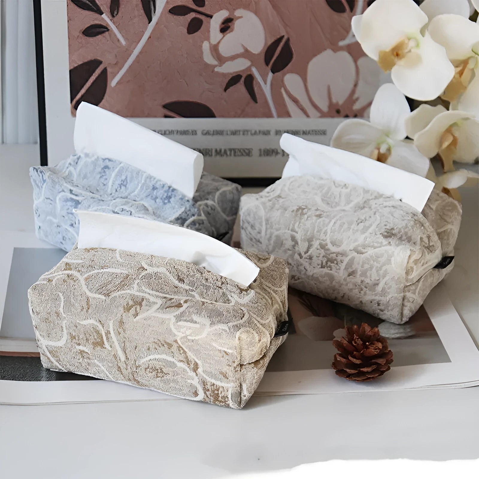 Pastoral style cotton fabric tissue box cover in beige, blue, and brown colours on a tea table.