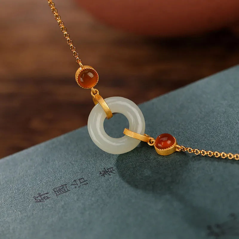 Women's S925 sterling silver gold-plated bracelet with inlaid natural Hetian jade and a peace buckle clasp.