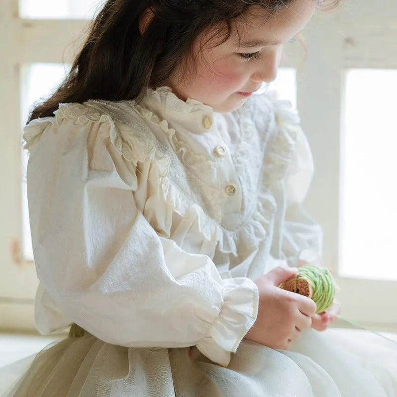 Cotton girls princess shirt with lace collar and long puff sleeves in beige on white background