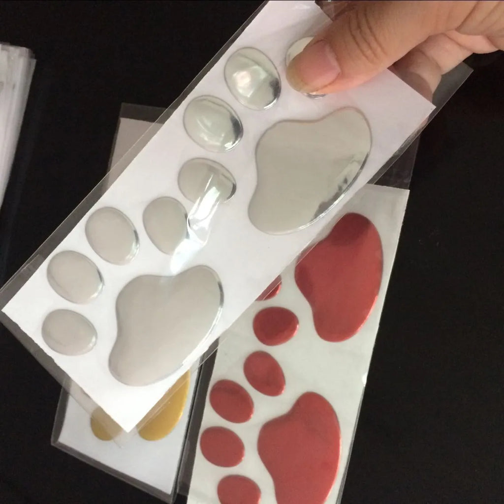 PVC car sticker with hand-shaped brush design showing dog footprints pattern measuring 7 cm length