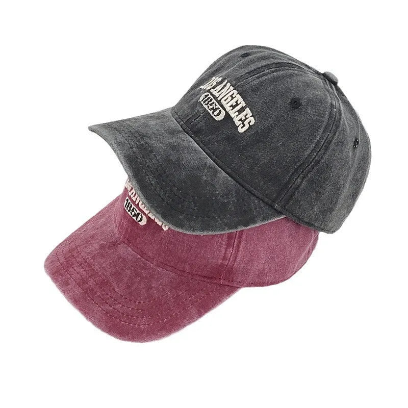 Retro beige personalised washed cotton peaked cap with adjustable strap and embroidered letters on the front.