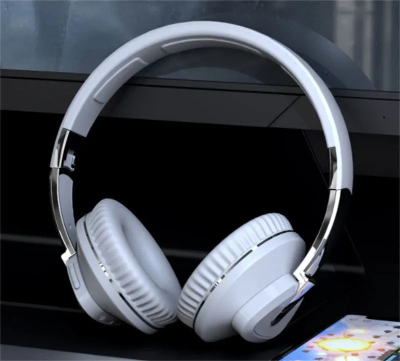 Black wireless over-ear Bluetooth headset with all-inclusive ear cups, showing AUX port and control buttons.
