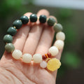 Bodhi root bracelet with gradient white jade and beeswax lotus pendants