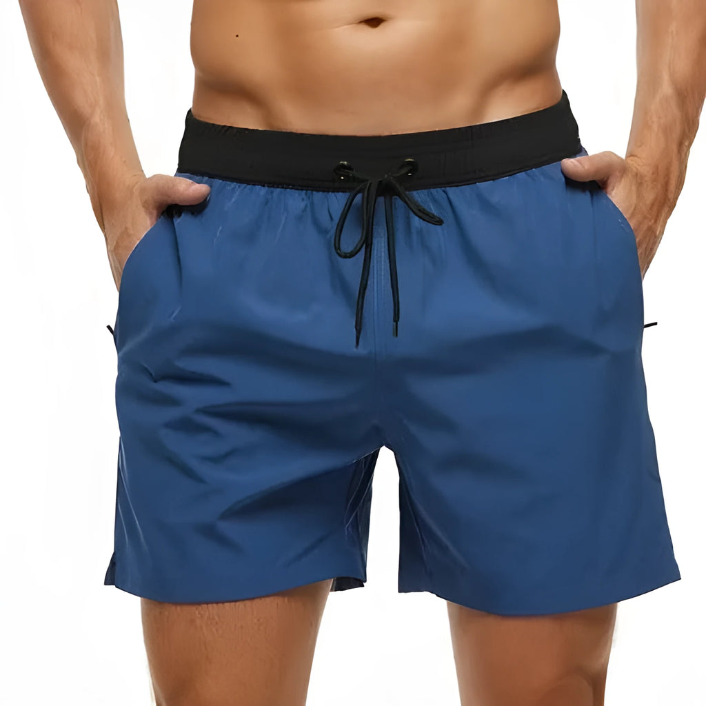 Men's blue stitching waist drawstring athletic shorts with a headband pocket and zipper fly.