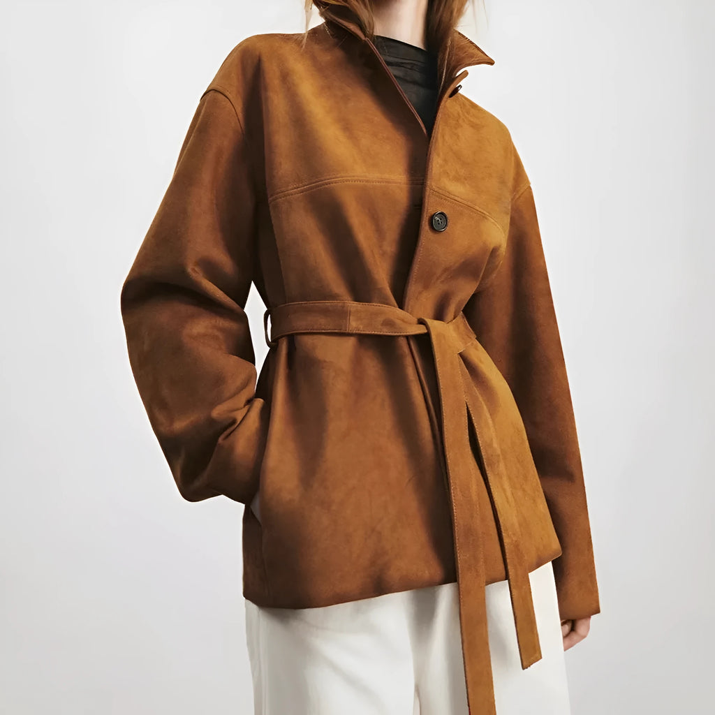Yellow brown cashmere mid-length coat with a leather belt and a flat Peter Pan collar on a hanger.