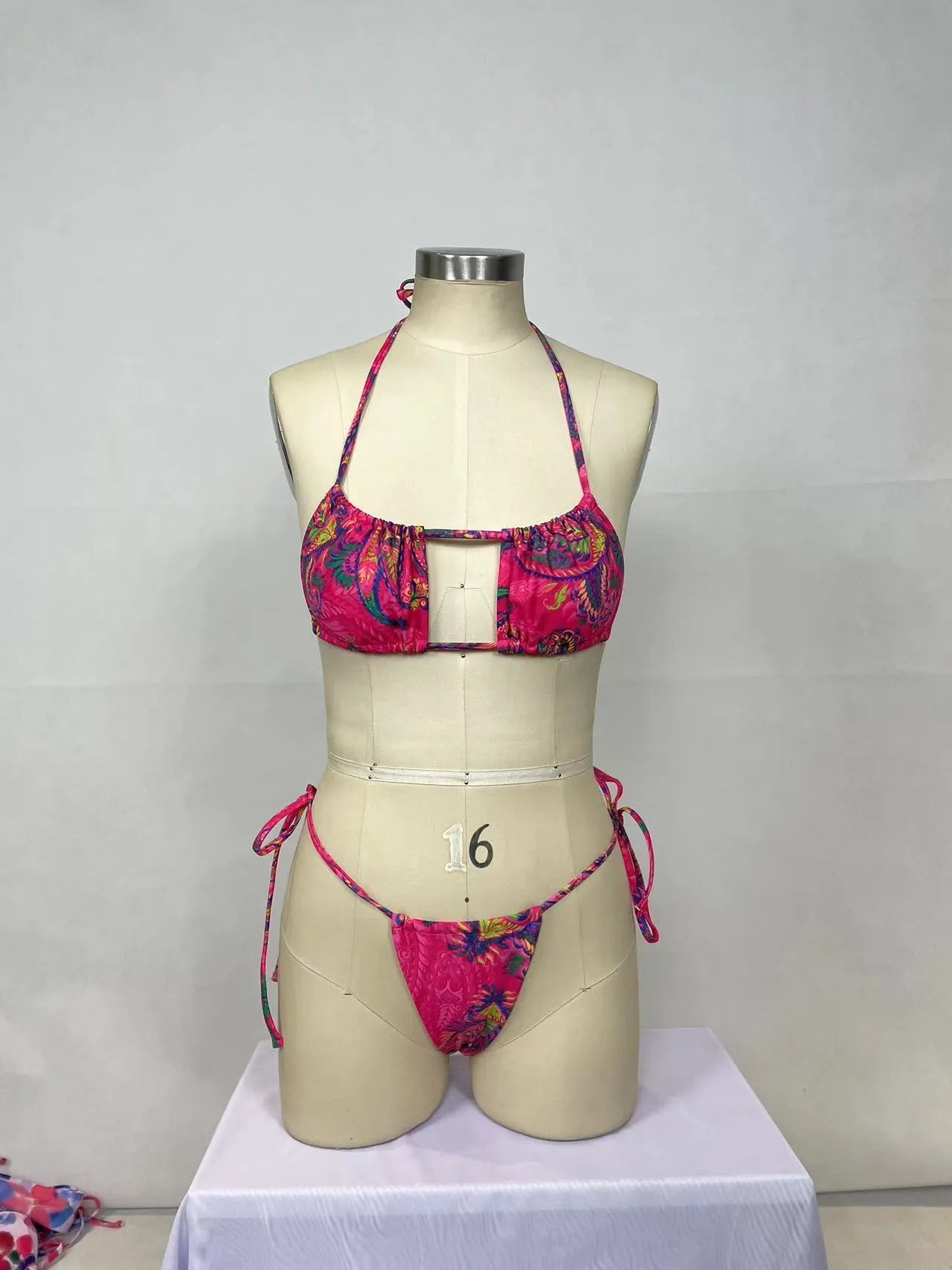 Pink printed women's bikini two-piece set with backless design for swimming.