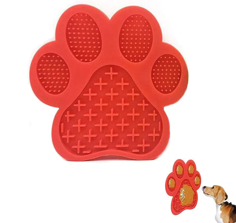 Blue bone-shaped silicone dog licking mat with suction cups on a tiled shower wall.