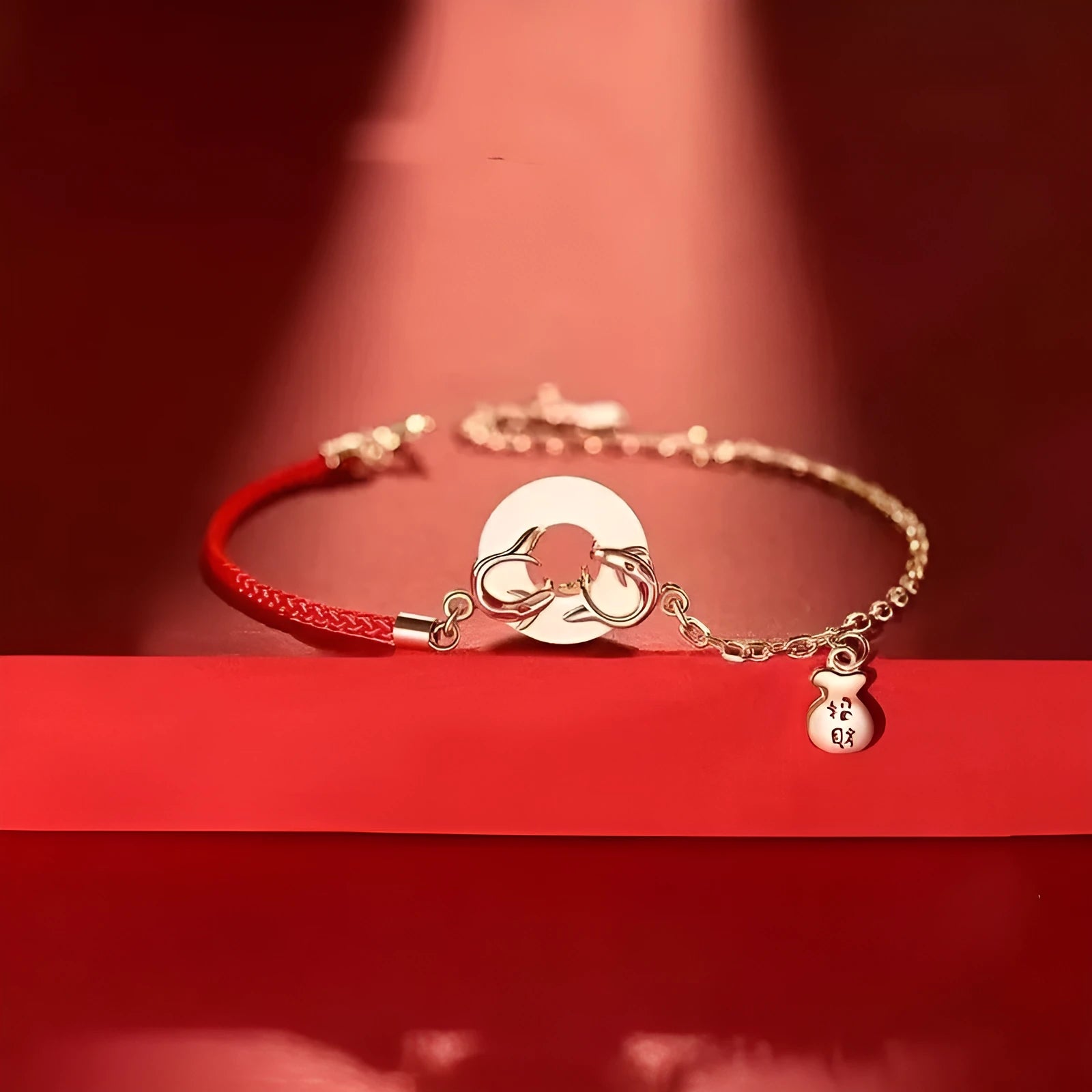 Festive Koi women's bracelet with red rope and peace buckle closure on a wrist.