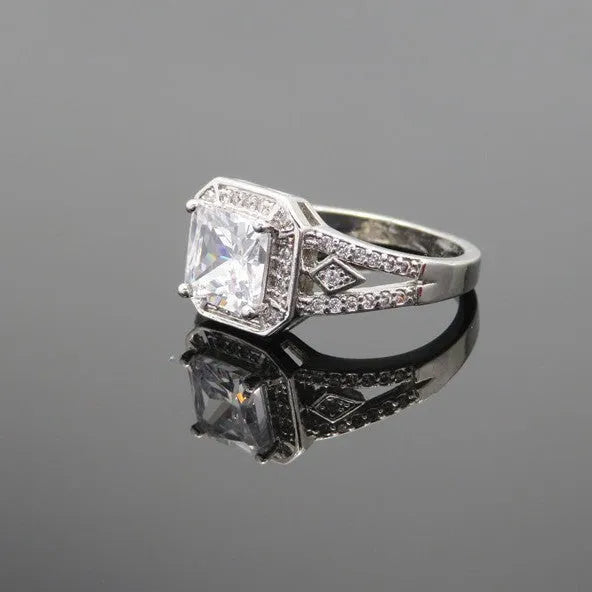 Hollow geometric zircon ring with quadrilateral detailing in platinum colour