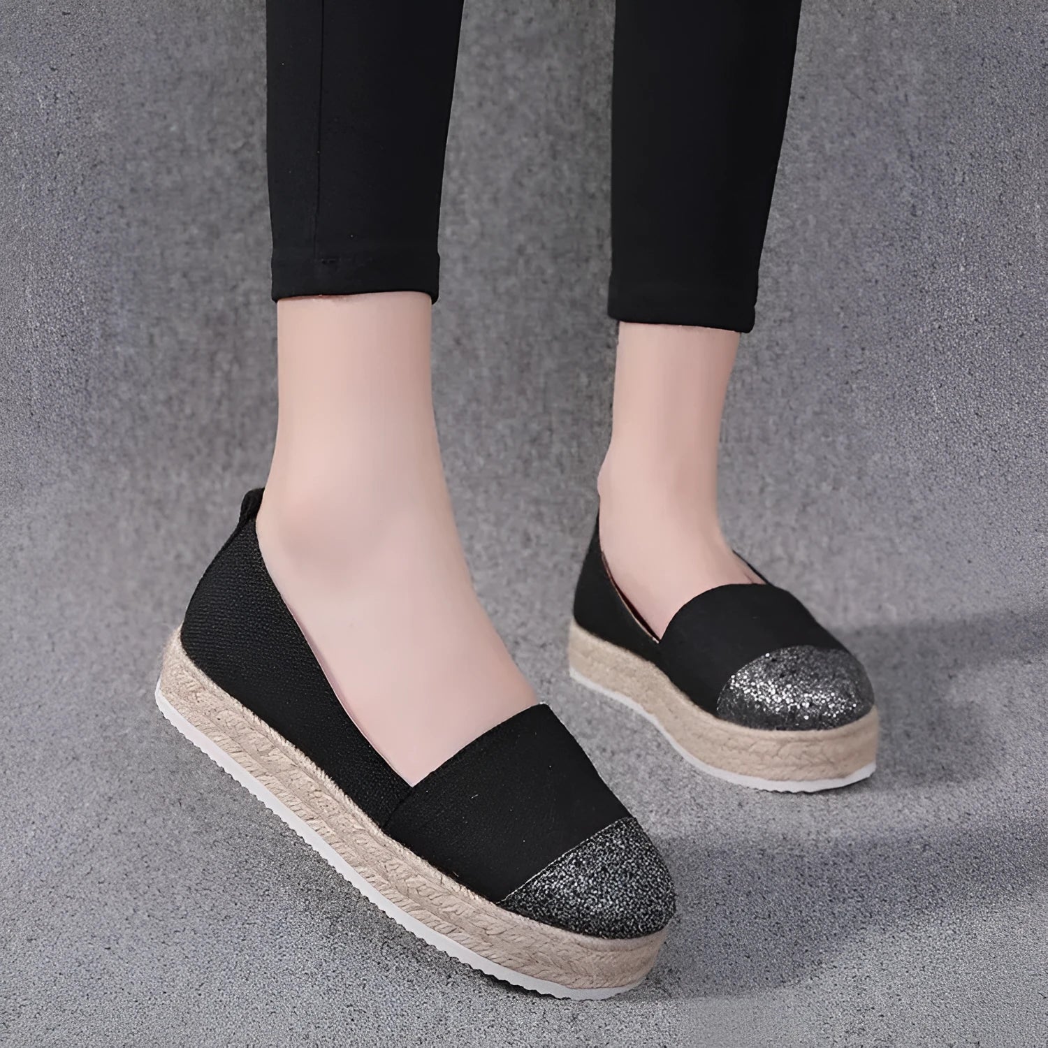 Plus size beige canvas slip-on flat shoes with a round toe on a white background.