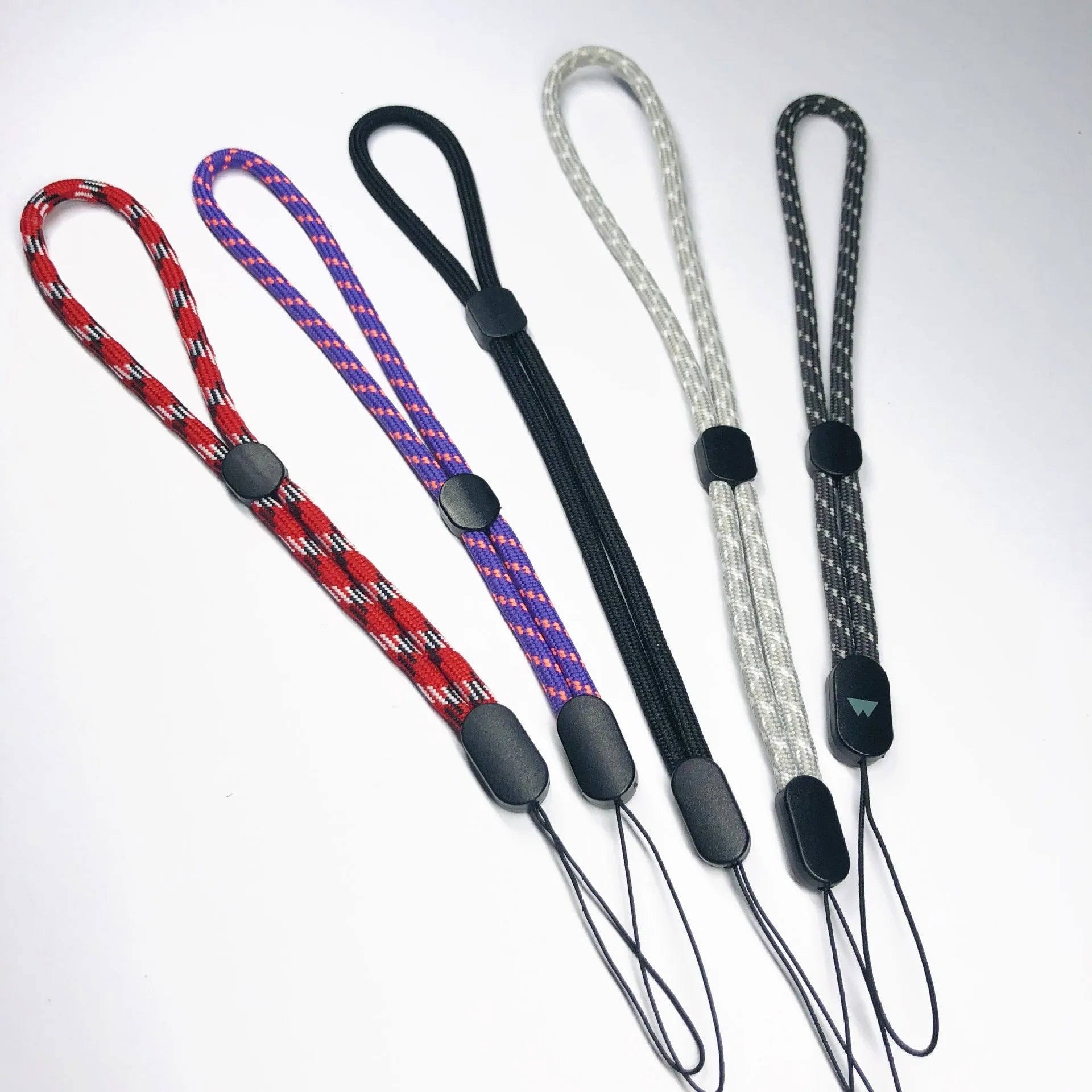Adjustable round woven mobile phone lanyard in pink, white, and black colours