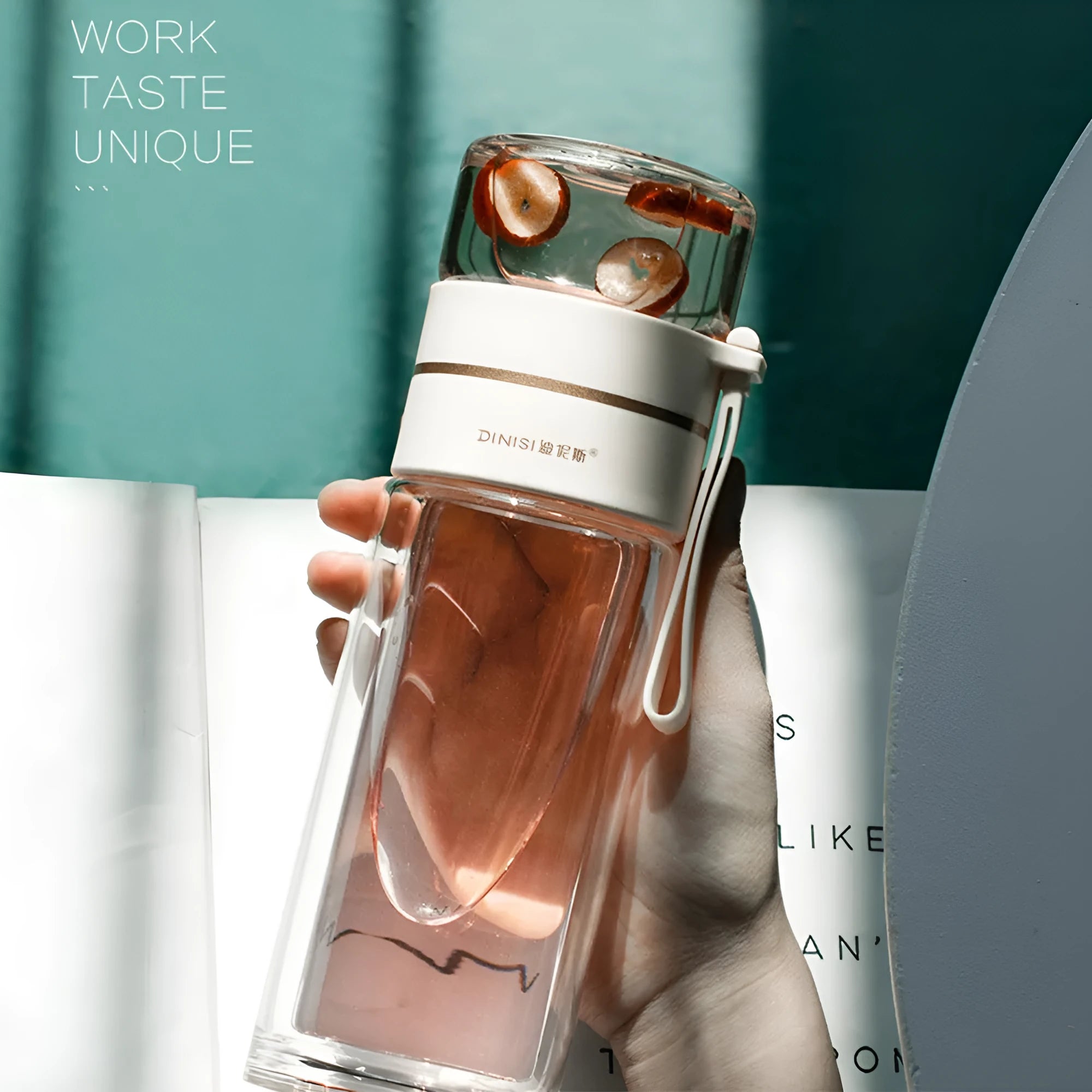 Green double-wall glass water bottle with a stainless steel tea infuser insert and a black leak-proof lid with rope handle.