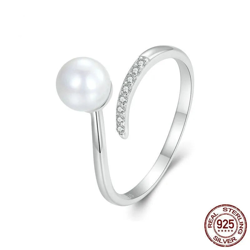 Adjustable open-loop sterling silver ring featuring a genuine shell pearl.
