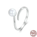 Adjustable open-loop sterling silver ring featuring a genuine shell pearl.