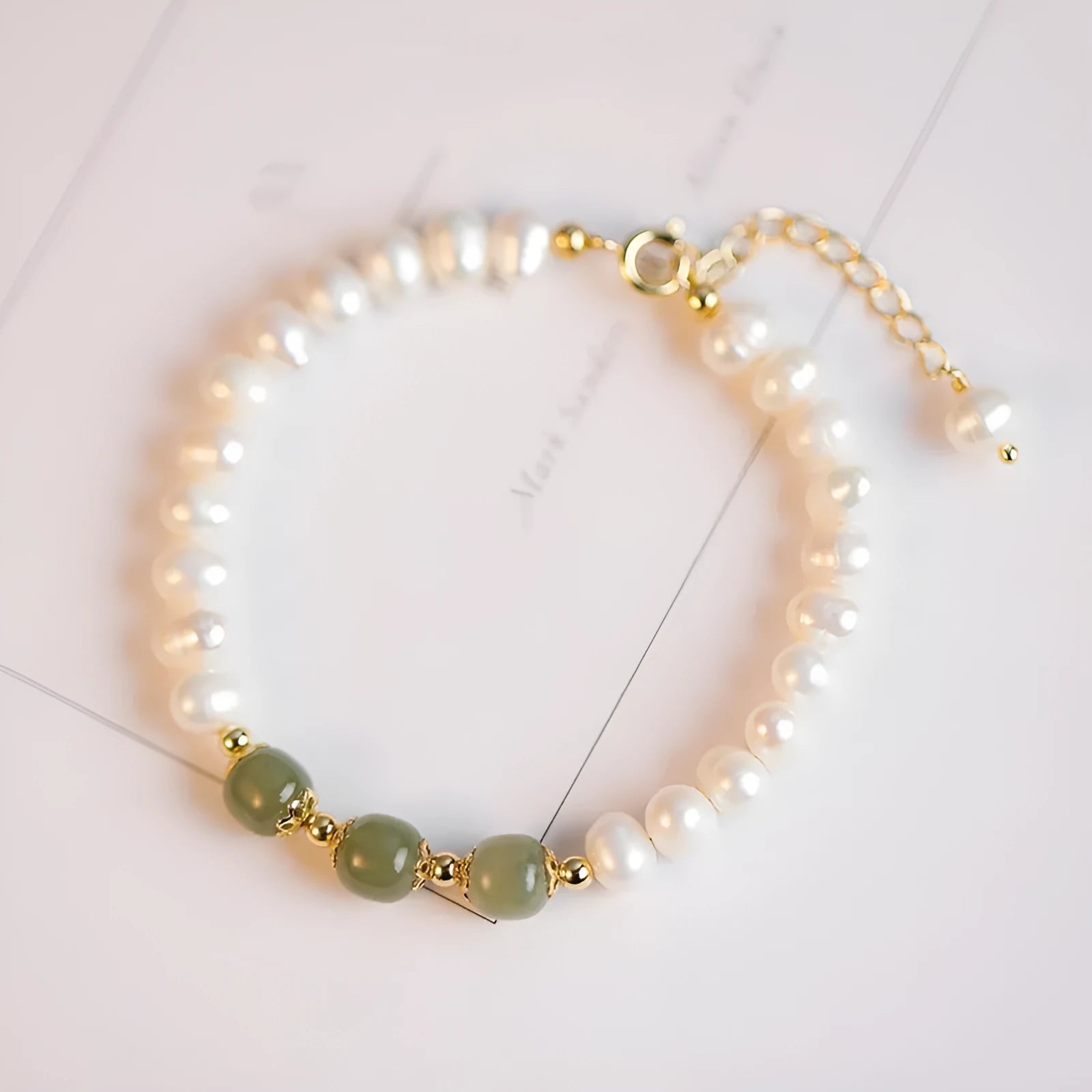 Natural freshwater pearl bracelet with a diamond-shaped electroplated pendant in Hetian jade colour.