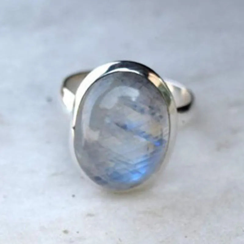 Silver alloy vintage Thai moonstone flower ring for women on plain background