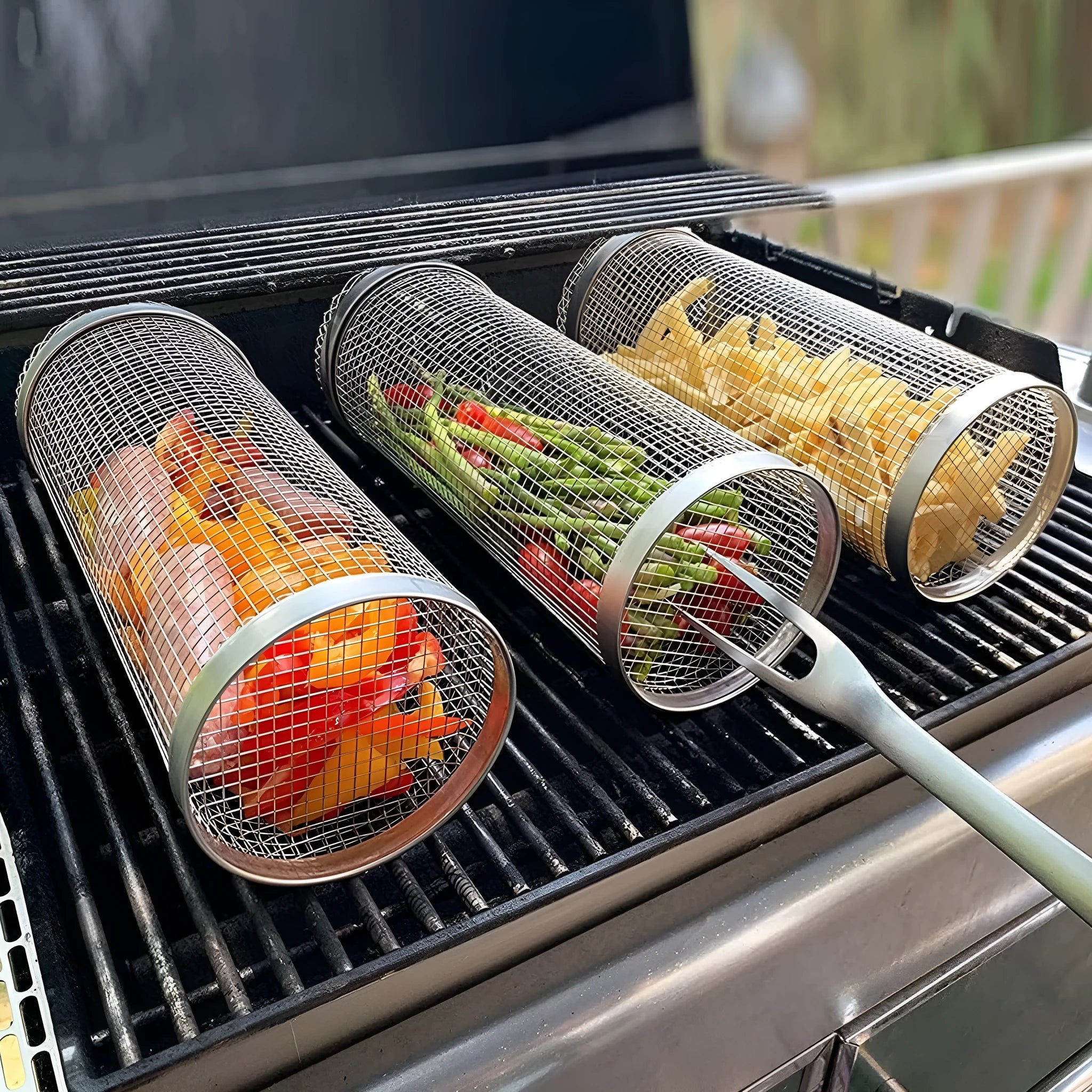 Stainless steel cylindrical rolling barbecue grilling basket with wire mesh on a grill.