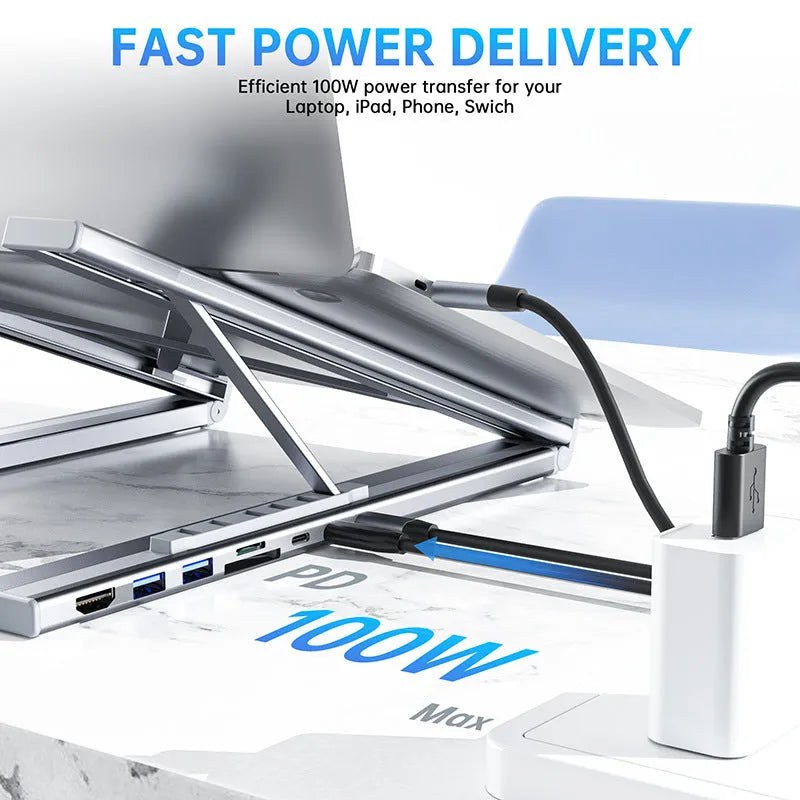Silver aluminium foldable laptop stand with integrated multi-port docking station and a short connection cable.