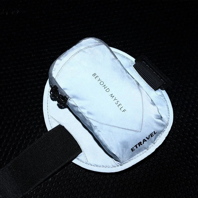 Black reflective running arm bag with adjustable strap, shown holding a large smartphone.