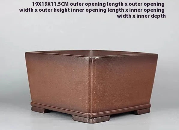 Brown handmade antique purple clay flower pot with classical styling.