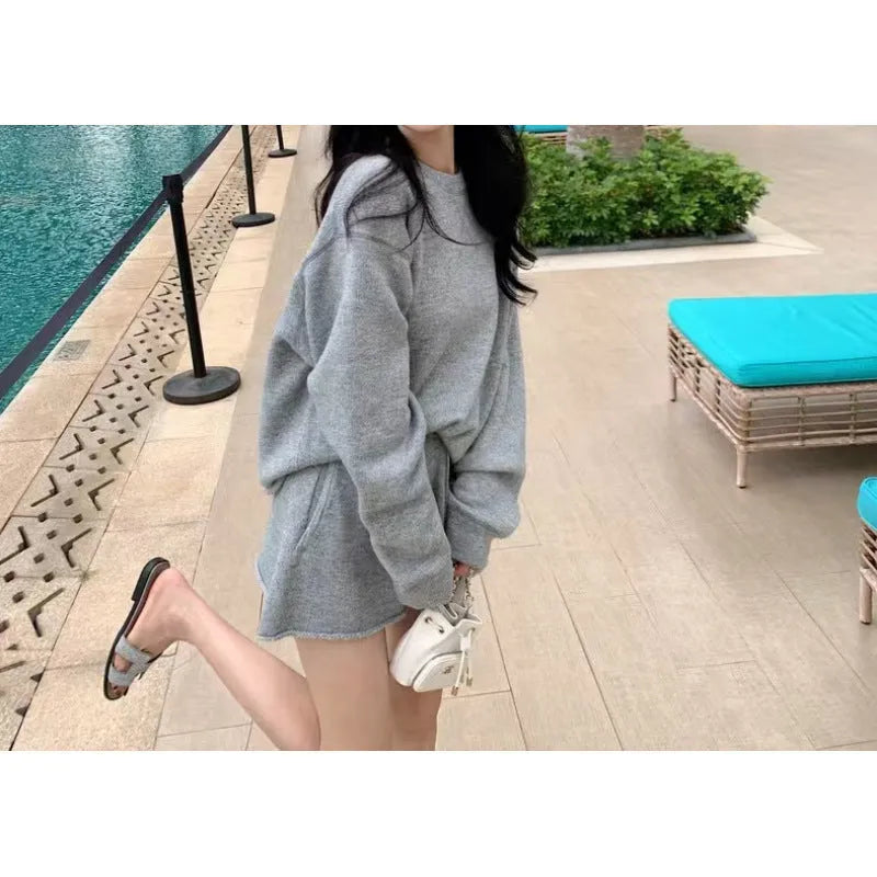 Women's loose-fit long sleeve acrylic knit sweater and matching wide-leg shorts set shown in oatmeal colour.